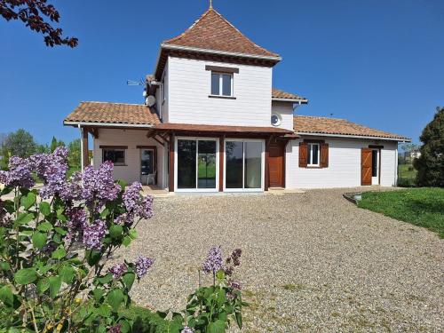 une maison avec une allée de gravier devant elle dans l'établissement Belle maison de campagne, à Puymiclan