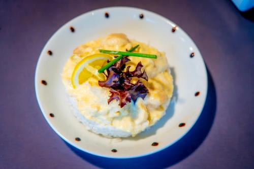 a white plate with food on a table at Campanile Evry Est - Saint Germain les Corbeil in Saint-Germain-lès-Corbeil
