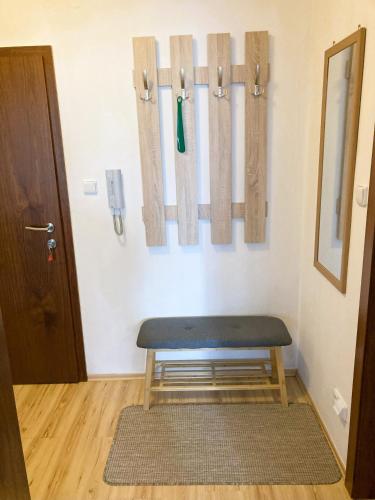 a room with a bench and bats on the wall at Apartmán KaTry in Veľká Lomnica