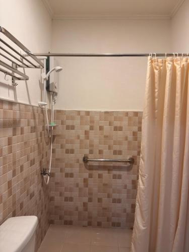 a bathroom with a shower curtain and a toilet at Casa Tres16 Quality Cheap WI-FI in Pilar
