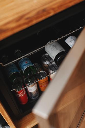 a drawer filled with lots of bottles of beer at Man Met Bril Koffie Hotel in Rotterdam
