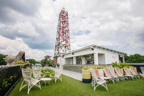 a group of chairs sitting on a patio with a tower at Hotel Clermont Atlanta, by Oliver in Atlanta