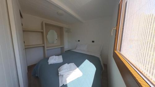 a small room with a bed and a window at Tigullio Camping & Resort in Sestri Levante