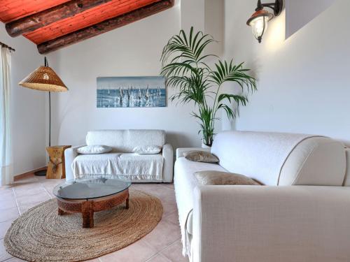 a living room with white couches and a coffee table at Holiday Home Nira by Interhome in Rabac