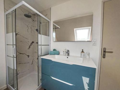 a bathroom with a sink and a shower at Holiday Home La Trélennoise by Interhome in Plonéour-Lanvern