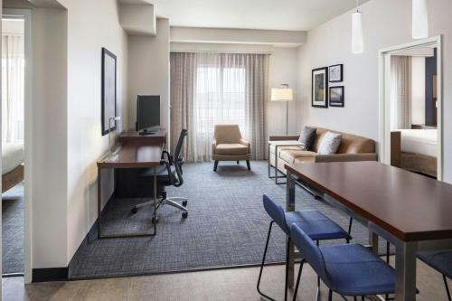 a hotel room with a desk and a living room at Residence Inn by Marriott Ann Arbor Downtown in Ann Arbor