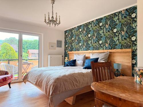 a bedroom with a large bed and a table at Ferienhaus Sonnenschein in Bad Reichenhall