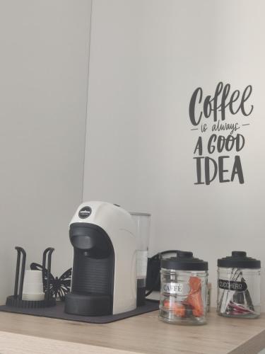 a kitchen counter with a coffee maker and a sign at Sapore di sale in Grottammare
