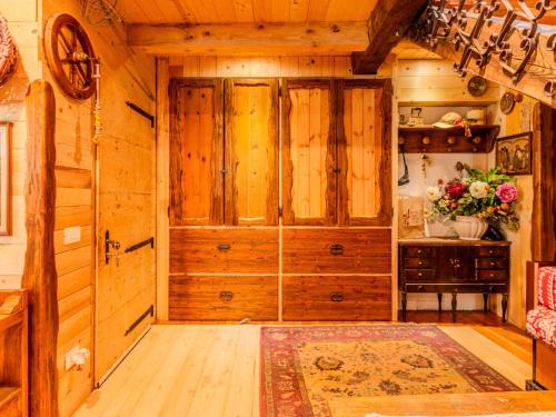 a room with a large wooden door in a cabin at Chalet Baita Ballardini by Interhome in Ragoli
