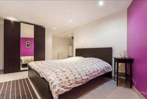 - une chambre avec un grand lit et des murs violets dans l'établissement 3 pièces Arc de Triomphe RDC, à Paris