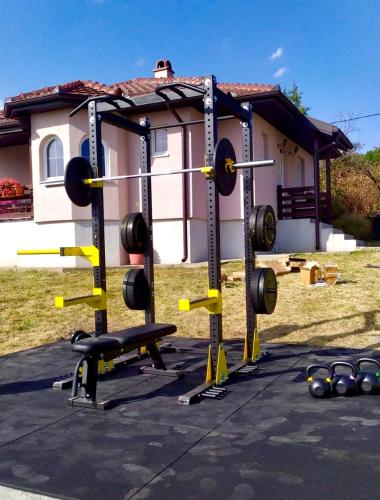 a gym with several equipment in front of a house at Zlatni Prag - Kraljevo in Kraljevo