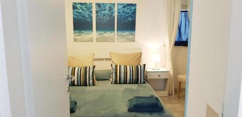 a bedroom with a bed with two pillows at La casa Rosa 2 in Ponza