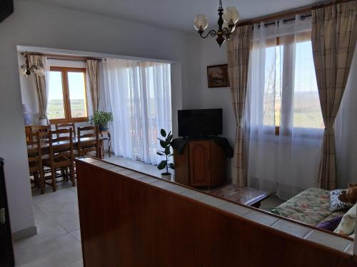 a living room with a couch and a tv in it at Maison Les Sables Un havre de paix au cœur de la in Bouzemont