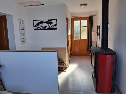 a room with a wood stove in a room at Maison Les Sables Un havre de paix au cœur de la in Bouzemont