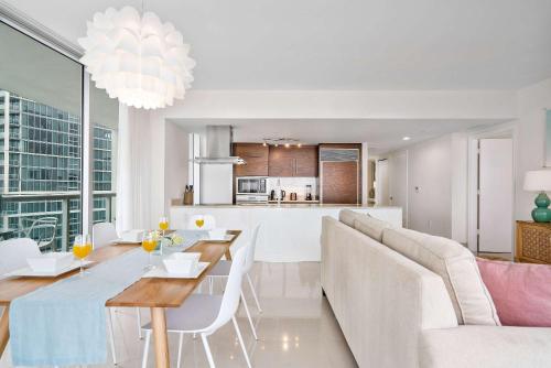 a living room and kitchen with a table and a couch at MVR - Designer Condo in Prime Brickell in Miami