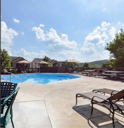 a large swimming pool with chairs at Libby's Perch No Stairs Outdoor Pool in Branson