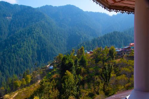 a view of a valley with trees and a mountain at Syanaik Adiyan House in Deoban