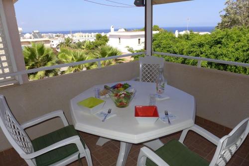 a white table and chairs on a balcony at Mediterraneo 27 - Protaras in Protaras