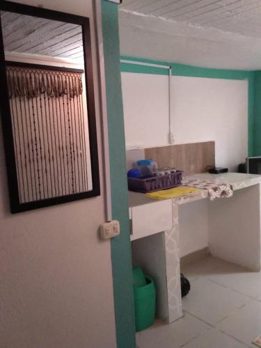a room with a kitchen with a table and a mirror at DESTINY Apto Parque in San Rafael