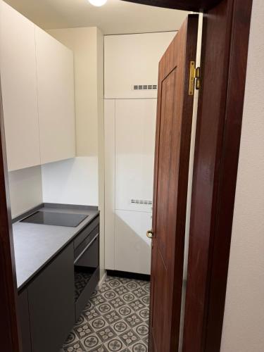 a kitchen with a door open to a small kitchen at A dream in Portofino Piazzetta in Portofino