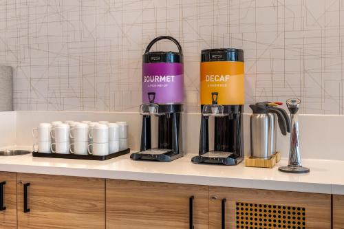 a kitchen counter with two blenders on a counter top at Home2 Suites By Hilton Bozeman Four Corners in Bozeman