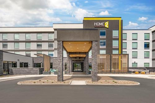 a hotel building with a sign that reads home at Home2 Suites By Hilton Bozeman Four Corners in Bozeman