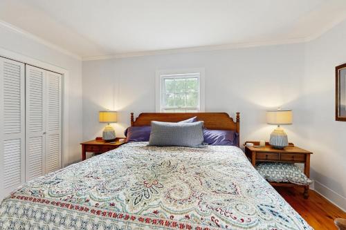 a bedroom with a large bed with two lamps at Seabreeze Manor in Camden