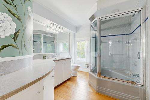a bathroom with a shower and a sink and a toilet at Seabreeze Manor in Camden
