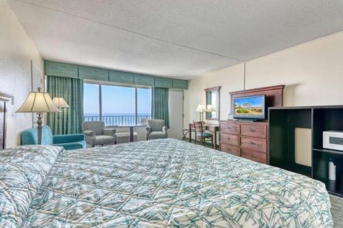 a hotel room with a bed and a television at Blockade Runner in Myrtle Beach