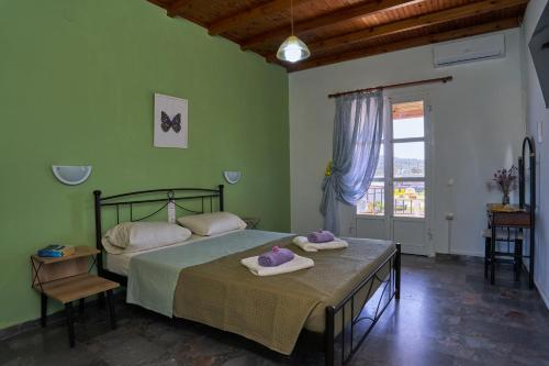 a bedroom with a bed with two towels on it at Elysee Seaview Apartments in Sidari