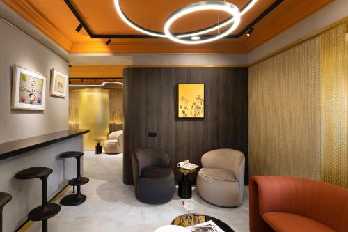 a lobby with a waiting room with chairs and a chandelier at Oborishte 63,The Art Boutique Hotel by Sandglass in Sofia