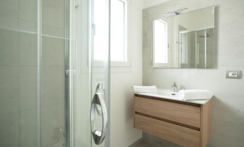 a bathroom with a sink and a shower at Appart NUOVO Sorgenti Sup by Salento Prime in Marina di Pescoluse