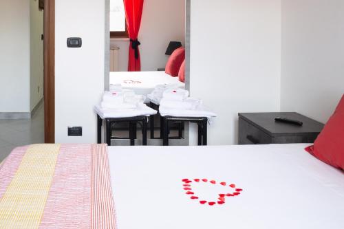 a room with two tables and chairs with a bed at Bed & Breakfast Cozy Hills in Cagli