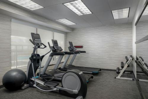 a gym with treadmills and exercise bikes in a room at Courtyard by Marriott Houston Rice University in Houston