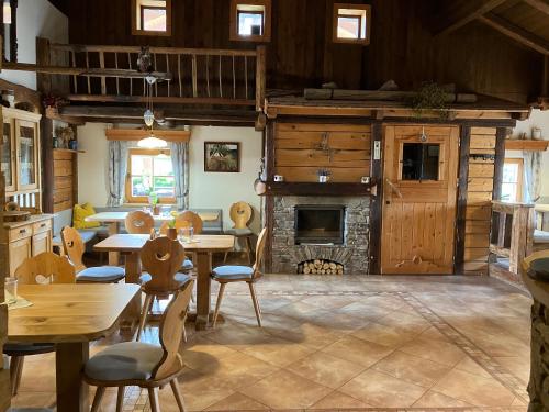 a dining room with tables and a fireplace at Jihočeská Salaš in Čakov
