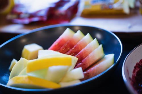 a blue bowl filled with cut up apples and cheese at Rectory Farm in Cambridge