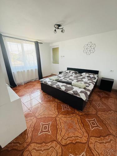 a bedroom with a bed in the middle of the room at Casa Dumitru in 2 Mai