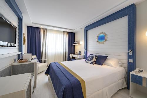 a hotel room with a large bed and a tv at Santemar in Santander