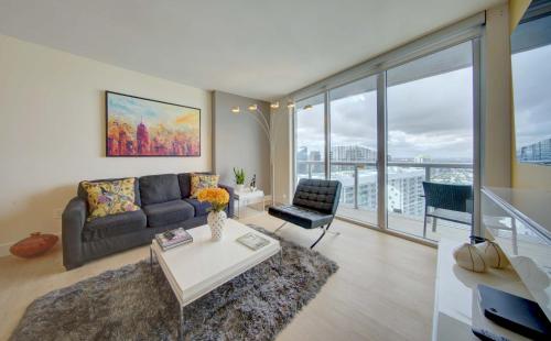 a living room with a couch and a table at MVR Balcony Bliss in Miami in Miami