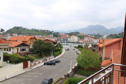 a view of a city street with cars on the road at Hotel Verdemar in Ribadesella