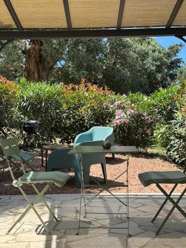 a table and two chairs and a table and chairs at Patios di Pruno Studio NINO in Figari