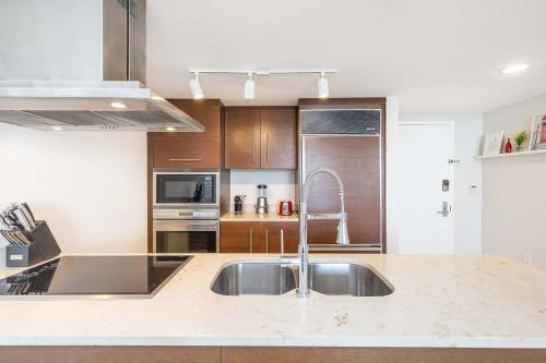 a kitchen with a sink and a counter top at MVR Bright & Airy Condo with Views in Miami