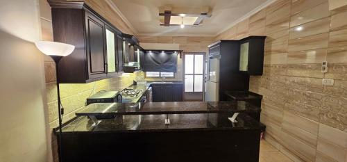 a kitchen with a counter top in a room at شقة مفروشة في طبربور 3 غرف نوم in Amman