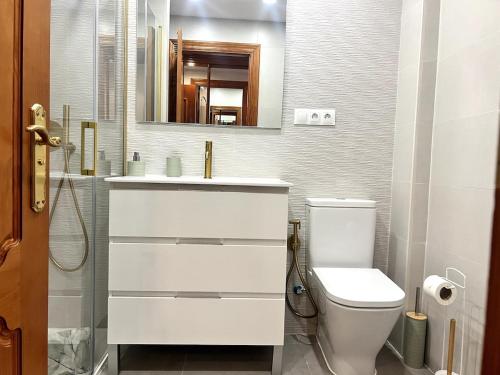 a white bathroom with a sink and a toilet at Apartamento Bellavista Close to the airport in Torremolinos