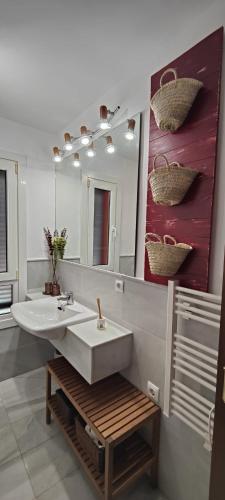 a bathroom with a sink and a mirror at Lunamar in San José