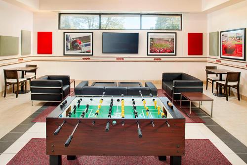 a living room with a pool table and a tv at Courtyard by Marriott Little Rock West in Little Rock