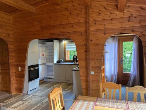 a kitchen with an archway in a wooden house at Ferienhaus-Kroeger-kostenloses-Wlan in Hasselfelde