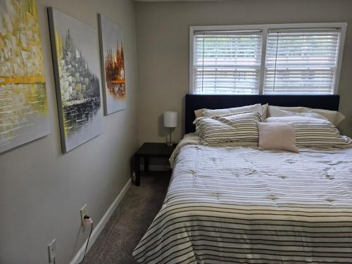 a bedroom with a large bed and a window at Perfect flat in Central Fayetteville, GA in Fayetteville