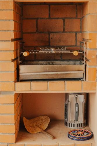a brick oven in a brick wall with a toaster oven at Torreira Beach Apartment in Torreira