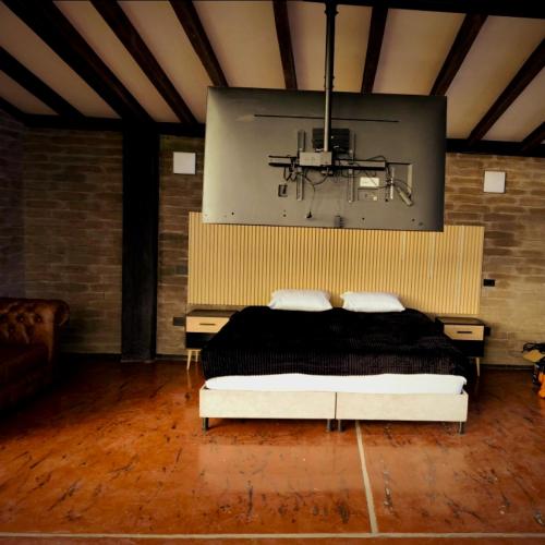 a bedroom with a bed and a large screen at Medellin cerca al aeropuerto Rionegro Antioquia in Rionegro
